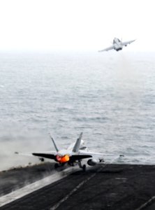US Navy 110918-N-QL471-273 An F-A-18C Hornet assigned to Strike Fighter Squadron (VFA) 15, right, and an F-A-18A- Hornet assigned to VFA 87 launch