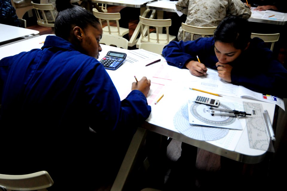 US Navy 110915-N-RC734-063 Culinary Specialist Seaman Angelena Moon, left, and Quartermaster Seaman Denise Perez take the E-4 advancement examinati