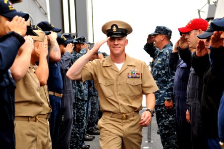US Navy 110916-N-ZF681-487 Sailors aboard USS Halsey (DDG 97) render a salute to Chief Electronics Technician Anthony Andersen as he departs the sh