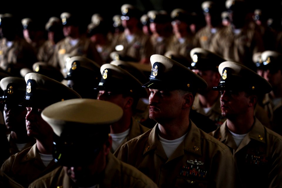 US Navy 110916-N-ZZ999-022 Chief petty officers listen to a speaker during the 2011 chief petty officer pinning ceremony aboard USS John C. Stennis