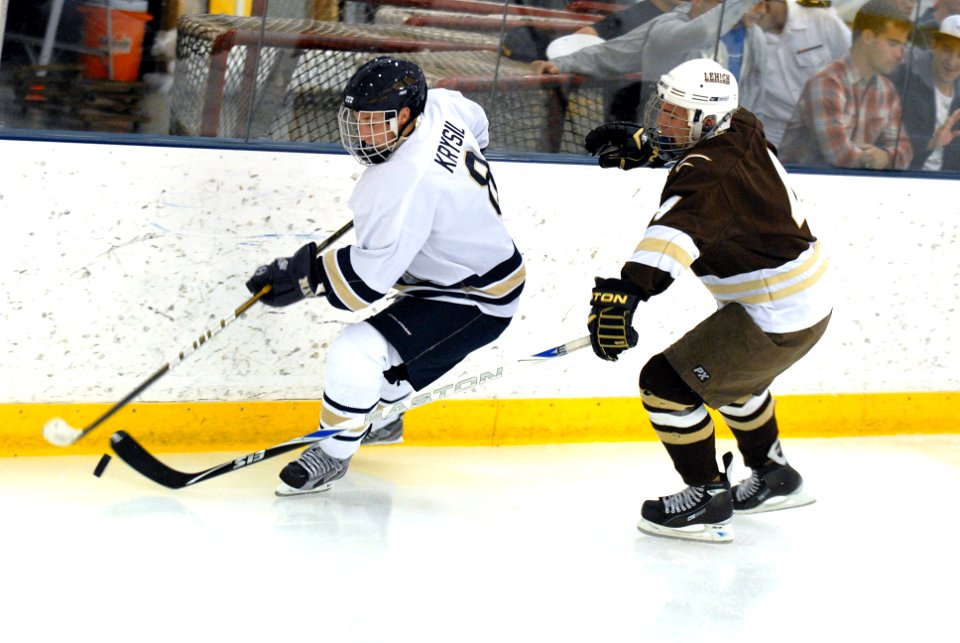 US Navy 110916-N-OA833-004 U.S. Naval Academy forward Tom Krysil tries to escape a Lehigh University defender during the Midshipmen's season-openin