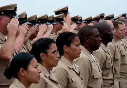 US Navy 110916-N-DR144-130 Sponsors salute the colors as chief petty officer selects wait to be pinned during the 2011 chief petty officer pinning
