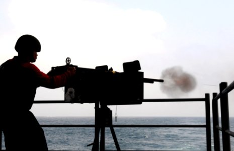 US Navy 110919-N-QJ471-503 Aviation Ordnanceman 3rd Class Gianfranco Francisco fires a .50-caliber machine gun during a live-fire exercise on the f