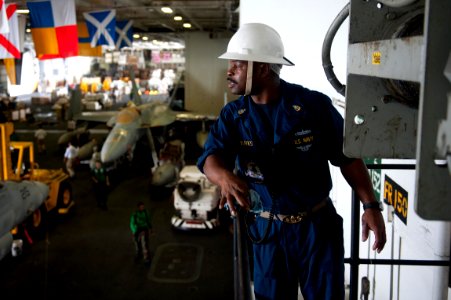 US Navy 110917-N-BT887-263 Senior Chief Boatswain's Mate John Burks observes the hoisting of a sliding pad eye after a replenishment at sea