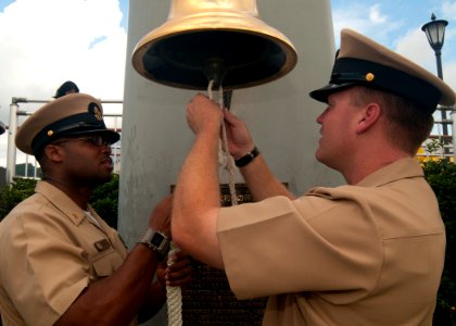 US Navy 110919-N-EA192-057 Chief Boatswain's Mate Adam Melancon, right, and Chief Ship's Serviceman Warren Brown splice a lanyard to a photo