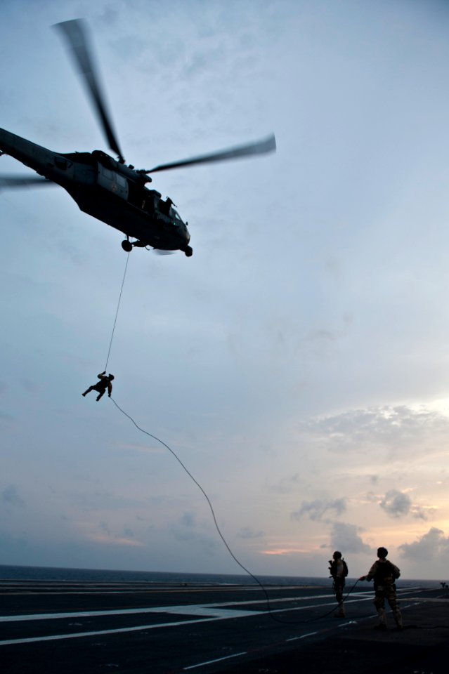 US Navy 110914-N-BT887-479 Sailors assigned to Explosive Ordnance Disposal Mobile Unit (EODMU) 11 rappels from an MH-60S Sea Hawk helicopter