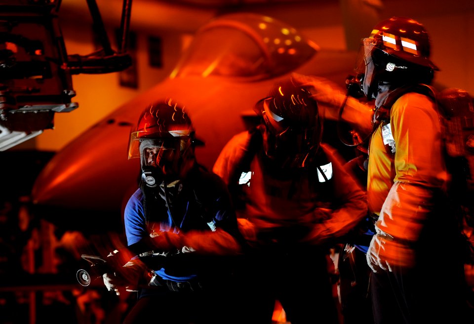US Navy 110917-N-DR144-049 Sailors battle a simulated aircraft fire in the hangar bay during a general quarters drill aboard the Nimitz-class aircr