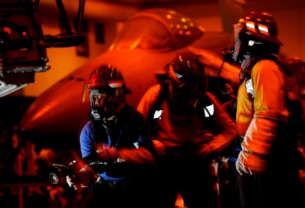 US Navy 110917-N-DR144-049 Sailors battle a simulated aircraft fire in the hangar bay during a general quarters drill aboard the Nimitz-class aircr