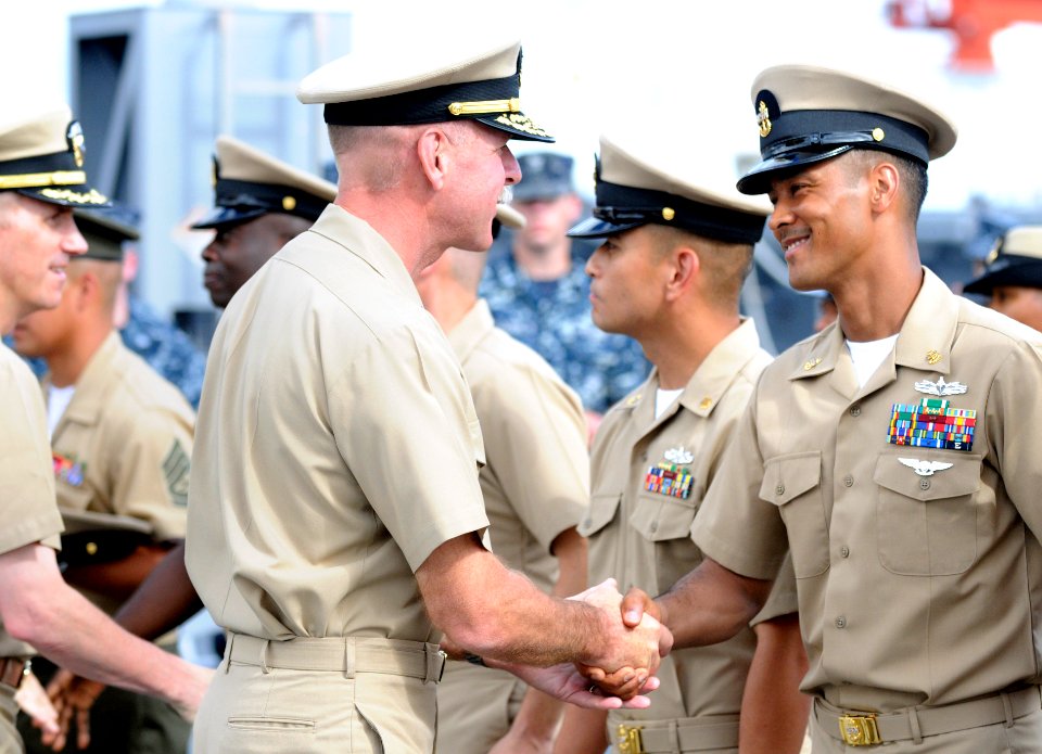 US Navy 110916-N-XG305-835 Vice Adm. Scott Swift, commander of U.S. 7th Fleet, congratulates Chief Aerographer's Mate Chi Maxey during a pinning ce