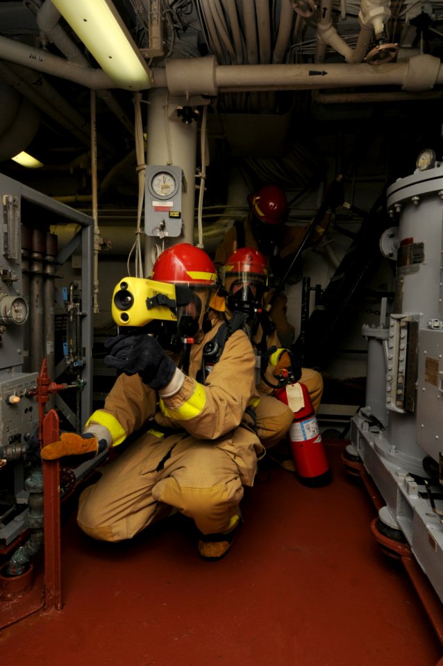 US Navy 110917-N-XQ375-046 Sailors assess the lower level of main engine room two during a fire drill aboard guided-missile destroyer USS Mitscher