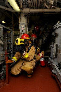 US Navy 110917-N-XQ375-046 Sailors assess the lower level of main engine room two during a fire drill aboard guided-missile destroyer USS Mitscher
