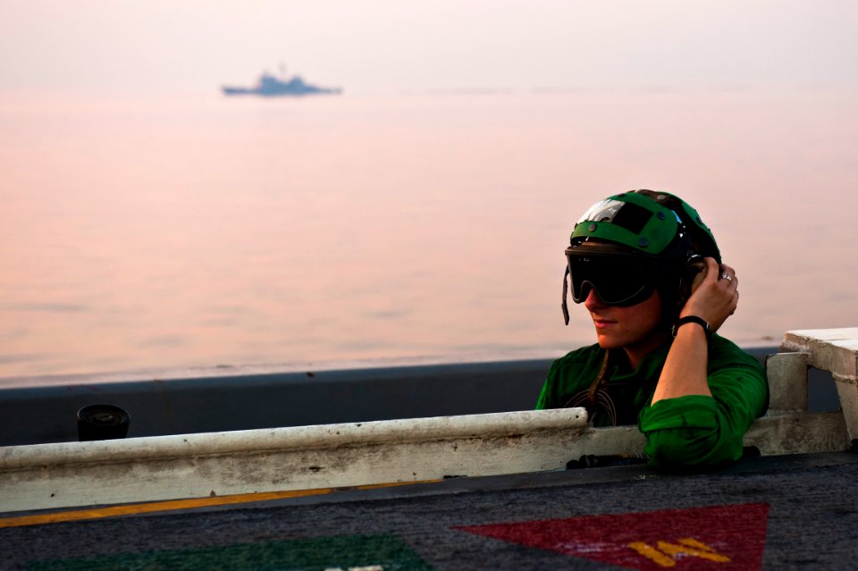 US Navy 110920-N-BT887-395 Aviation Boatswain's Mate (Equipment) Airman Monica Tallerico mans a sound-powered telephone during flight operations ab