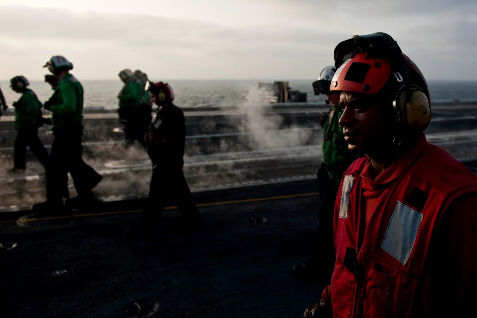 US Navy 110917-N-BT887-335 Sailors participate in a foreign object debris walk-down on the flight deck of the Nimitz-class aircraft carrier USS Joh