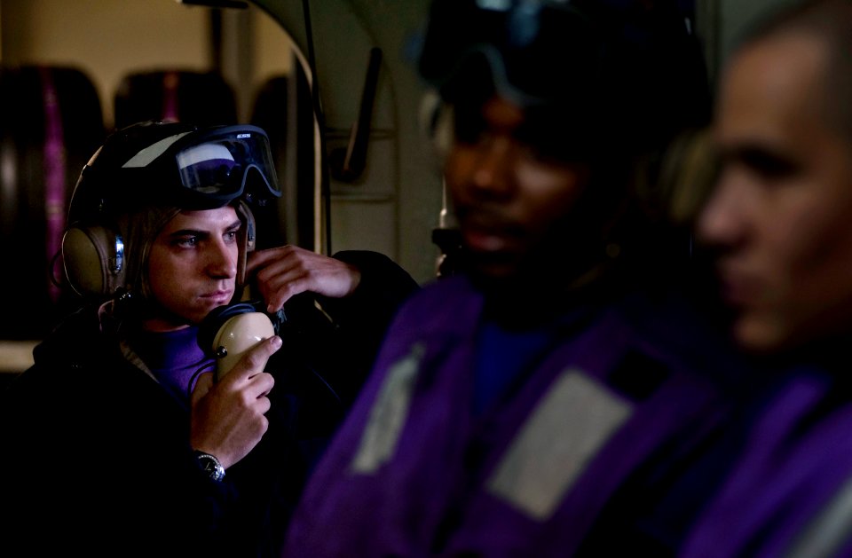 US Navy 110919-N-DR144-096 Aviation Boatswain's Mate (Fuels) Airman Jason Van Pelt communicates with below-decks pump rooms from a refueling statio