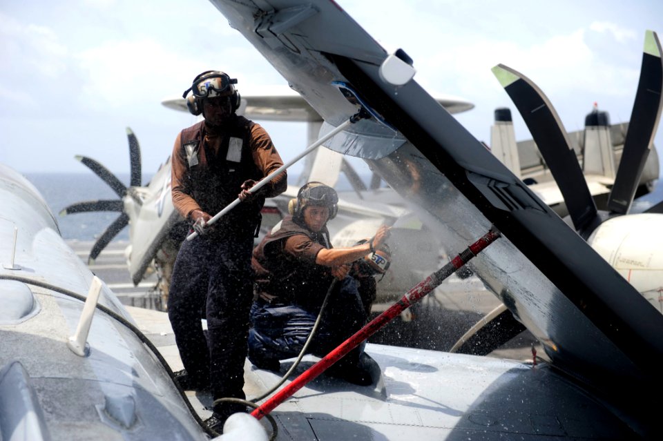 US Navy 110915-N-ZZ999-412 Airman Wellington O'Kene, from Warri, Nigeria, scrubs down an EA-6B Prowler assigned to the Wizards of Electronic Attack