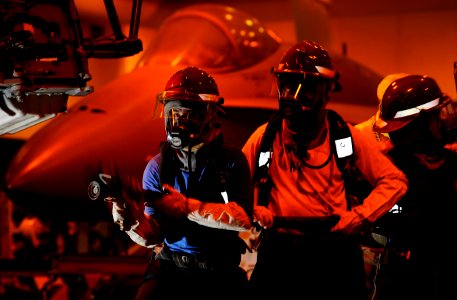 US Navy 110917-N-DR144-053 Sailors battle a simulated aircraft fire in the hangar bay during a general quarters drill aboard the Nimitz-class aircr