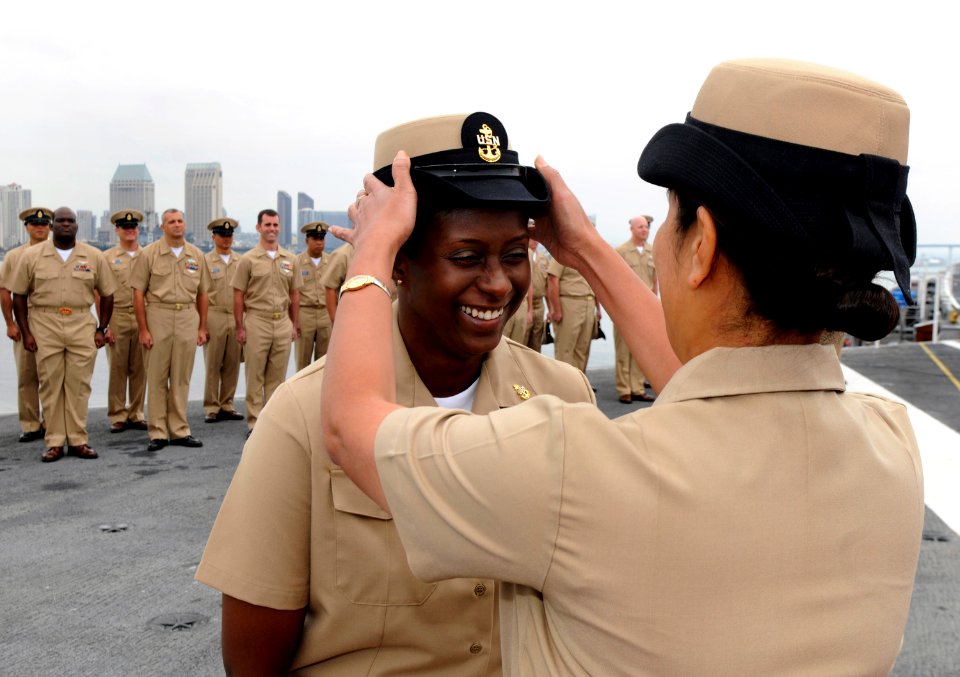 US Navy 110916-N-GZ277-270 Chief Aviation Maintenance Administrationman Rosalind Samuels receives her combination cover during the 2011 chief petty