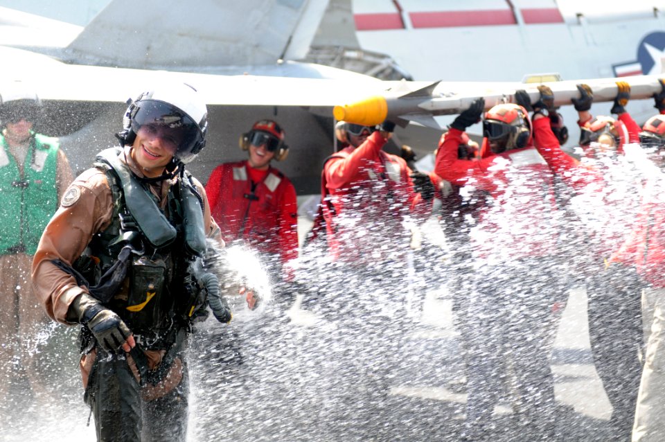 US Navy 110917-N-QL471-346 Cmdr. Christopher T. Petrock is sprayed with water after an aerial change of command ceremony aboard USS George H.W. Bus