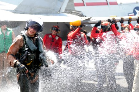 US Navy 110917-N-QL471-346 Cmdr. Christopher T. Petrock is sprayed with water after an aerial change of command ceremony aboard USS George H.W. Bus