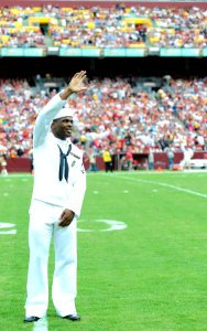 US Navy 110919-N-KV696-219 Master-at-Arms 3rd Class Quentin Benjamin waves to Washington Redskins fans while being honored during the Military Appr
