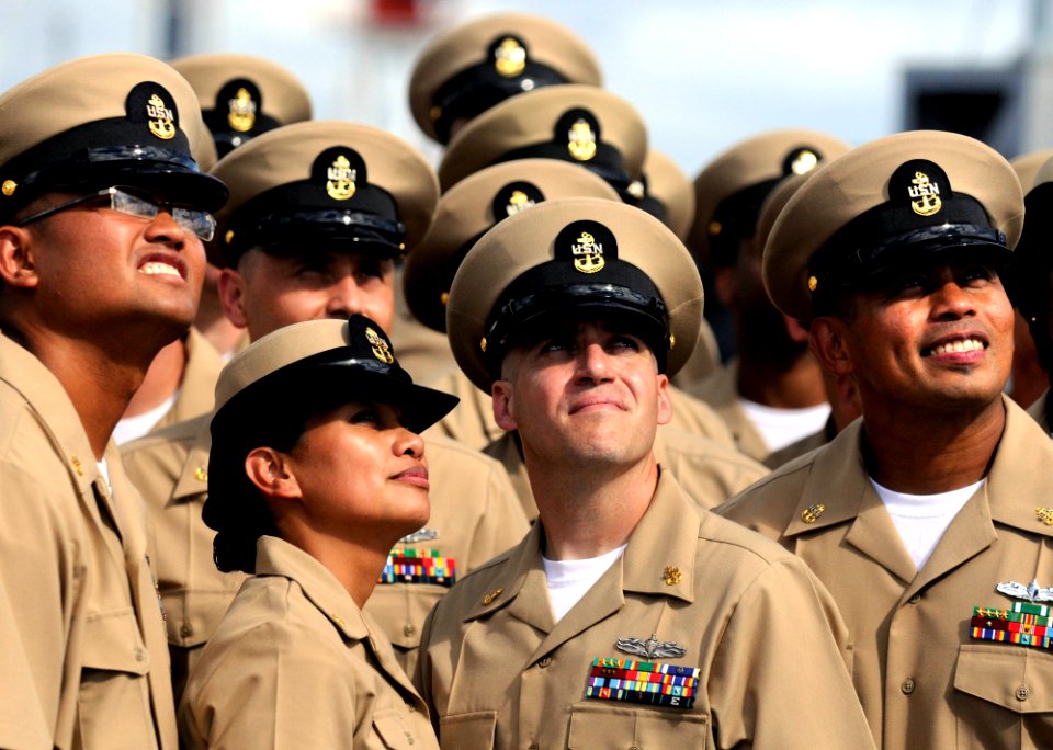US Navy 110916-N-XG305-839 Newly pinned chief petty officers pose for a group photograph after a pinning ceremony aboard the U.S. 7th Fleet command