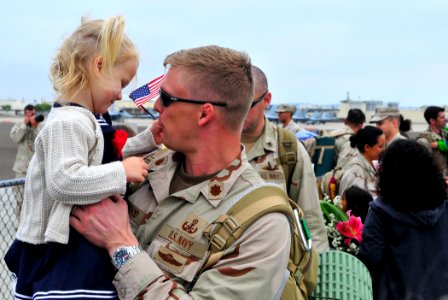 US Navy 110918-N-KB563-180 Lt. Cmdr. Karl Haywood holds his daughter as Explosive Ordnance Disposal Group (EODGRU) 1 returns to Naval Air Station N