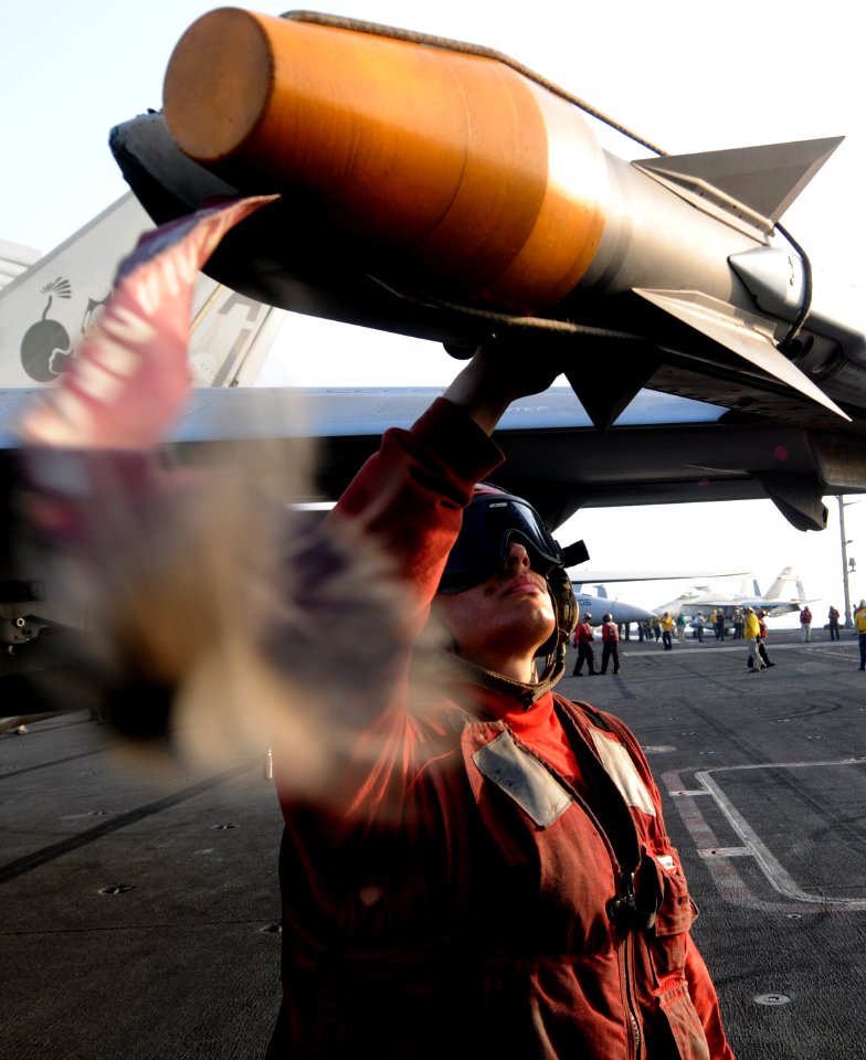 US Navy 110919-N-XE109-599 Aviation Ordnanceman 3rd Class Michael R. Soto performs pre-flight checks on ordnance attached to an F-A-18E Super Horne