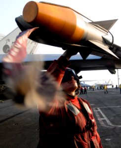 US Navy 110919-N-XE109-599 Aviation Ordnanceman 3rd Class Michael R. Soto performs pre-flight checks on ordnance attached to an F-A-18E Super Horne