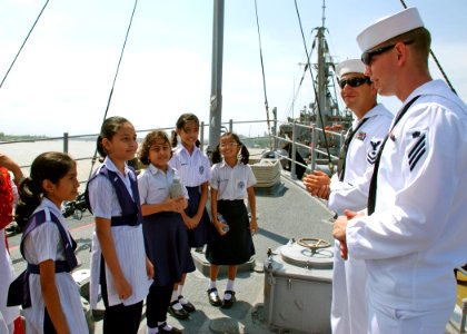 US Navy 110919-N-VP123-080 Mineman Seaman Tom Tate and Mineman 2nd Class Clifton Boyd explain what a mine countermeasures ship does