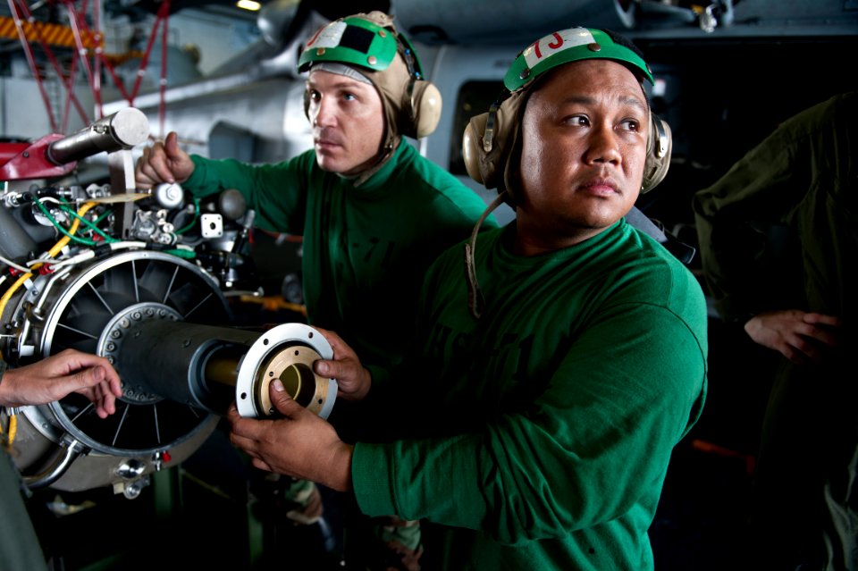 US Navy 110919-N-BT887-326 Aviation Machinist's Mate 1st Class Gerald Reynoso, from Lucena City, Philippines, checks for a clear path before moving