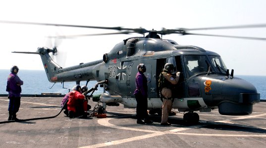 US Navy 110922-N-GH121-093 Sailors refuel a German marine Lynx helicopter aboard the amphibious dock landing ship USS Whidbey Island (LSD 41)
