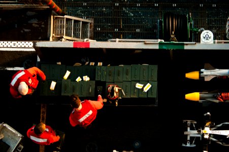 US Navy 110920-N-BT887-133 Aviation ordnancemen stack ammunition containers in the bomb farm aboard the Nimitz-class aircraft carrier USS John C. S
