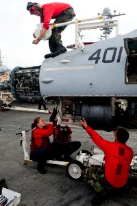 US Navy 110917-N-BT887-178 Aviation ordnancemen hoist an M61A1 machine gun into an F-A-18C Hornet assigned to the Golden Dragons of Strike Fighter