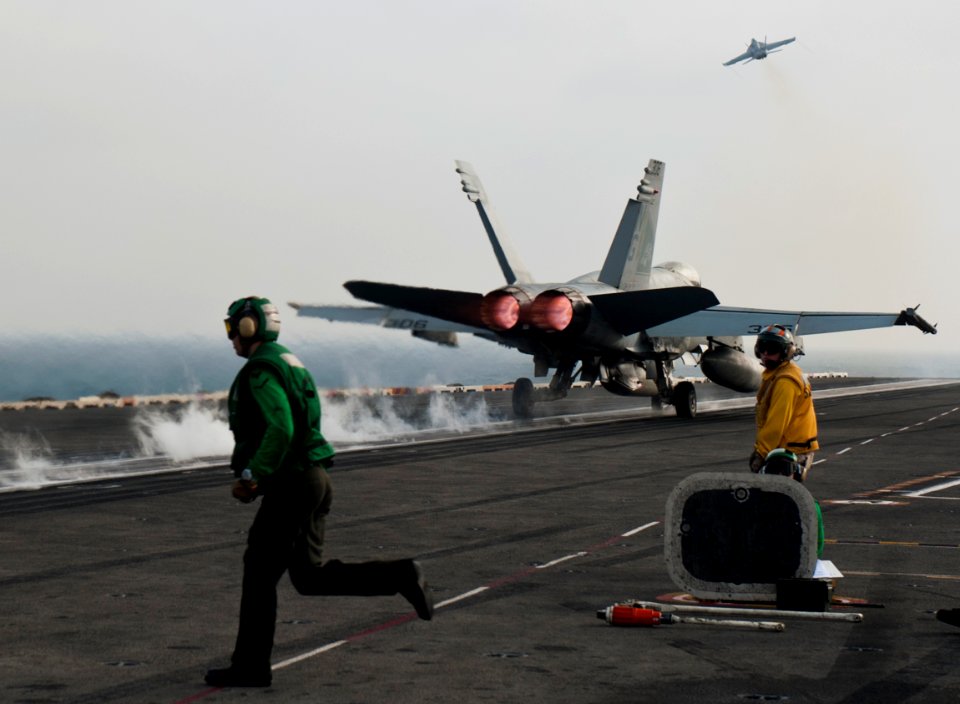 US Navy 110917-N-BT887-437 Sailors reset the catapult after an F-A-18E Super Hornet assigned to the Tophatters of Strike Fighter Squadron (VFA) 14
