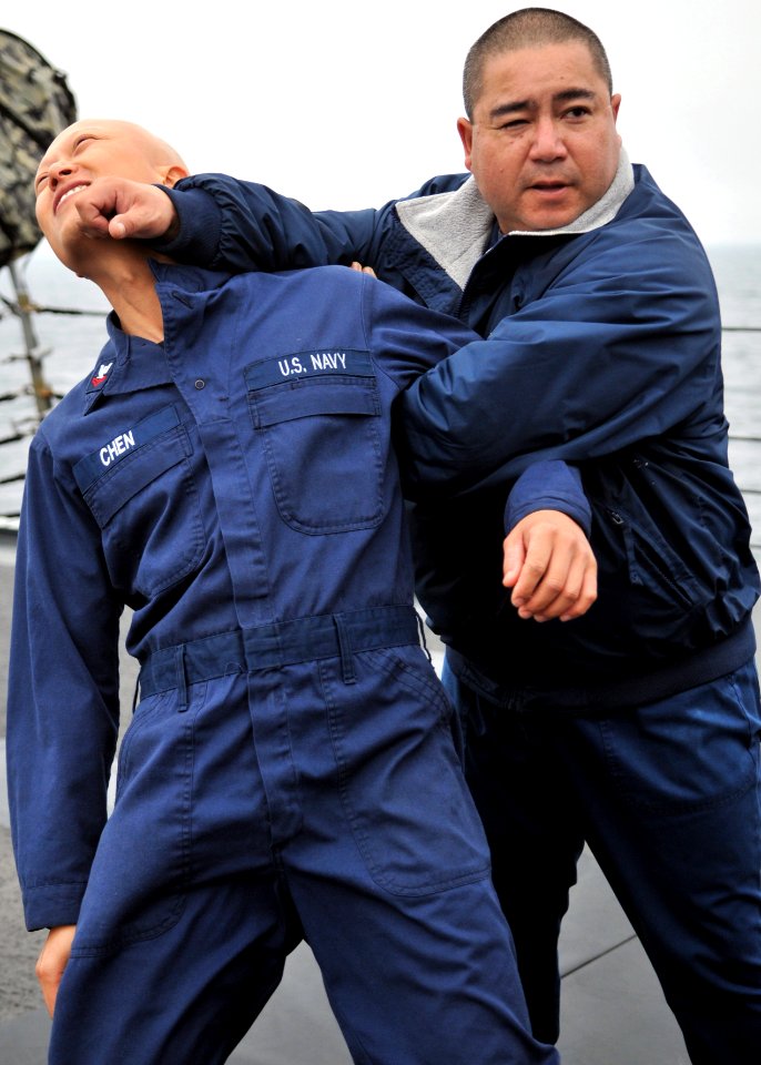 US Navy 110919-N-ZF681-423 Chief Gunner's Mate Jason Mitchell demonstrates proper takedown techniques on Information Systems Technician 2nd Class H