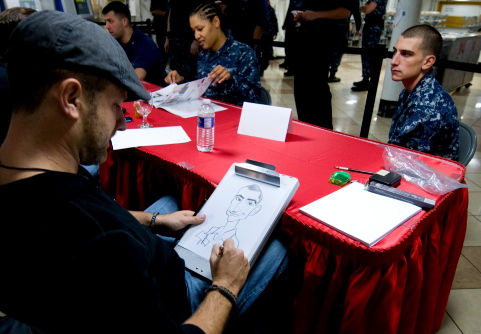 US Navy 110918-N-OK922-356 Stephen Silver draws a caricature for Ship's Serviceman Seaman Recruit Stephen Synakowski as part of Navy Operational St