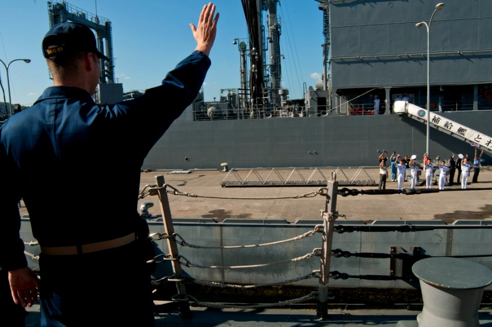 US Navy 110922-N-EA192-023 Lt. Michael Bono waves goodbye to members of the Japan Self-Defense Force as the the guided-missile destroyer USS Mustin