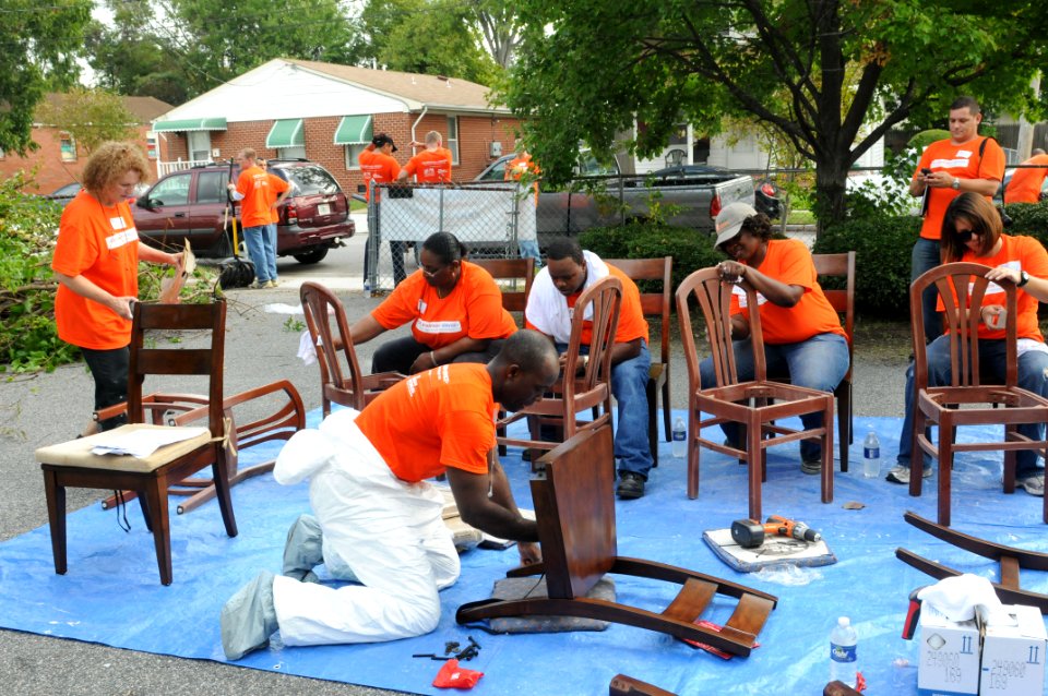 US Navy 110921-N-JK632-607 Service members and Home Depot employees fix dining room chairs at the Barrett Transitional Home during a community serv