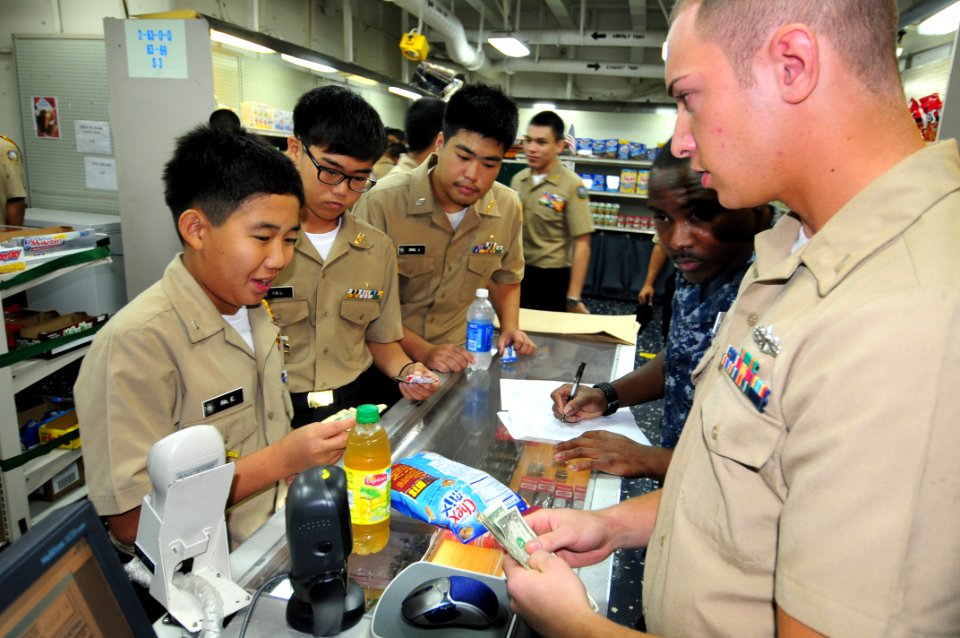 US Navy 110923-N-CB621-016 A Navy Junior ROTC cadet from Father Duenas Memorial School makes a purchase from Ship's Serviceman Seaman Mark Seward