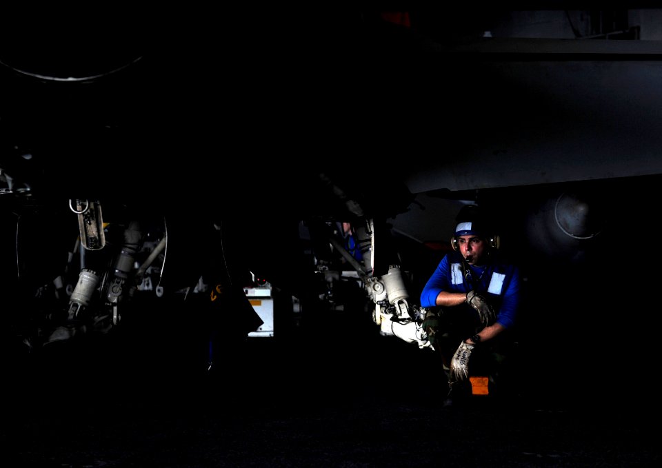 US Navy 110920-N-VN693-188 Aviation Boatswain's Mate Airman Jose Morales, from Santa Isabelle, P.R., prepares to remove chalks and chains before mo