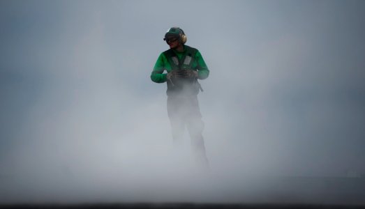 US Navy 110922-N-TU221-075 A Sailor stands as a safety observer during a test of the forward catapults aboard the Nimitz-class aircraft carrier USS