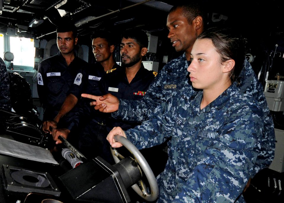 US Navy 110921-N-KK935-919 Lt. j.g. Kareen Washington explains the ship's bridge equipment to Bangladesh navy sailors aboard the guided-missile des