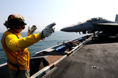 US Navy 110921-N-XE109-263 Lt. Cmdr. Ronald G. Rancourt directs an F-A-18F Super Hornet assigned to Strike Fighter Squadron (VFA) 213