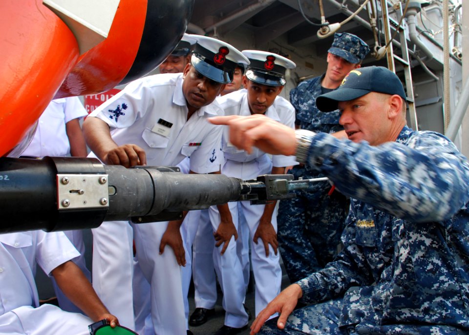 US Navy 110920-N-VP123-066 Senior Chief Mineman Bran Vonnahme, right, points out capabilities on a mine neutralization vehicle to Bangladesh navy s