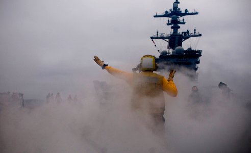 US Navy 110923-N-TZ605-124 Aviation Boatswain's Mate (Handling) 2nd Class Jason Querido, assigned to Air Department's V-1 Division, directs aircraf