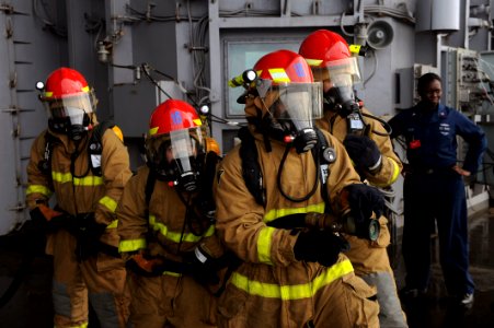 US Navy 110923-N-AU622-052 Members of Repair Locker 1-B practice fighting a fire during a general quarters and mass casualty drill