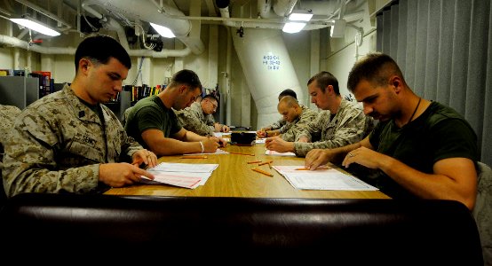 US Navy 110922-N-CT127-008 Sailors assigned to the 22nd Marine Expeditionary Unit (22nd MEU) take the late advancement exam in the library aboard t