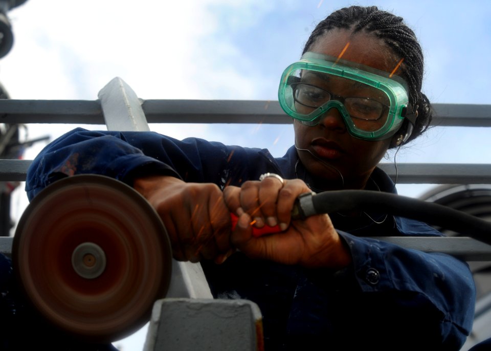 US Navy 110924-N-FI736-011 Seaman Samantha Pandy performs preservation maintenance aboard the guided-missile destroyer USS Arleigh Burke (DDG 51)