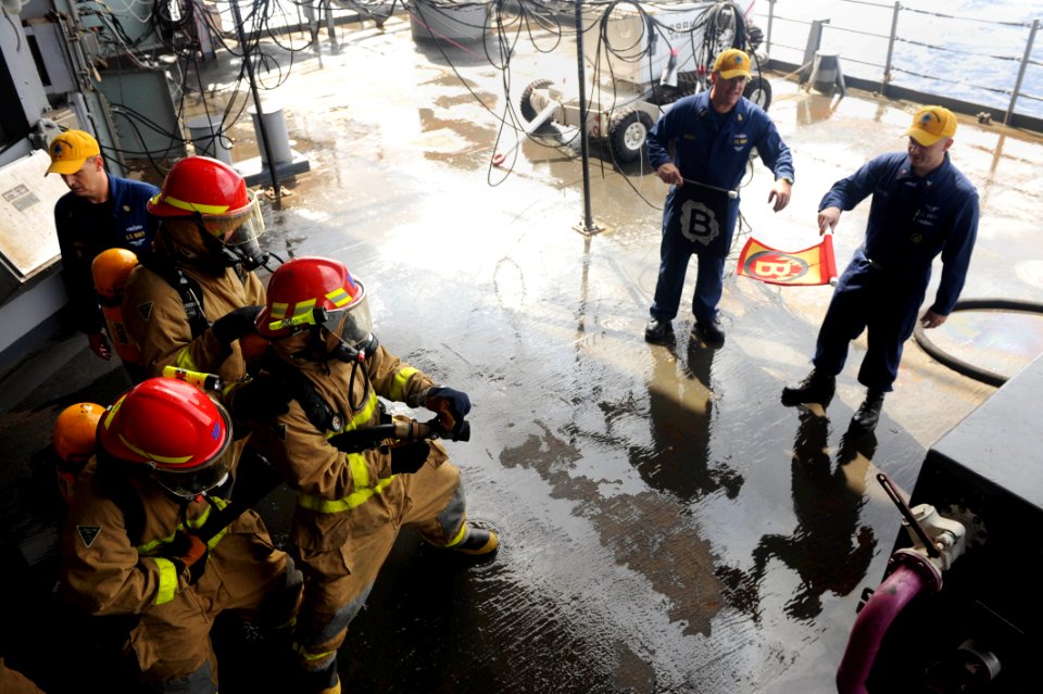 US Navy 110923-N-AU622-041 Members of Repair Locker 1-B practice fighting a fire during a general quarters and mass casualty drill