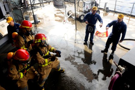 US Navy 110923-N-AU622-041 Members of Repair Locker 1-B practice fighting a fire during a general quarters and mass casualty drill